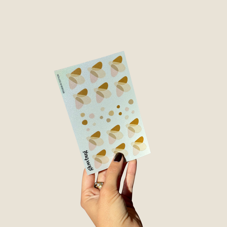 bogen mit reflektierenden stickern in der beigebug edition in hand gehalten als detail shot